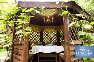 a wooden gazebo with a table in it at Vik-Jan in Khmelnytskyi