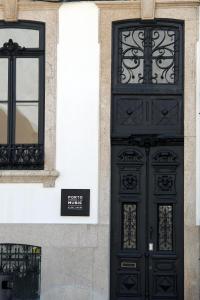 a building with a clock mounted to the side of it at Porto Music Guest House in Porto