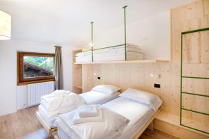 En eller flere senge i et værelse på Ostello Alpino