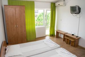 Postel nebo postele na pokoji v ubytování Tiberius Residence