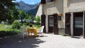 a table and chairs sitting outside of a building at Gite Seguret in Gresse-en-Vercors