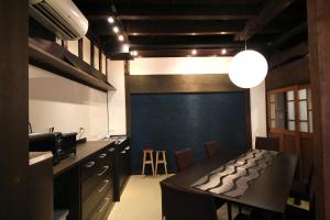 a kitchen with a table and a blue wall at Hakodate Classic Hotels in Hakodate