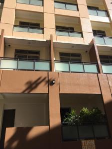an apartment building with a shadow of a building at Umali Kayo at Megatower Residences II in Baguio