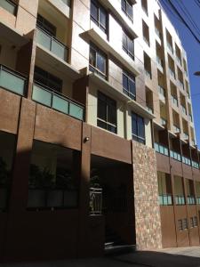 an apartment building with a parking garage in front of it at Umali Kayo at Megatower Residences II in Baguio