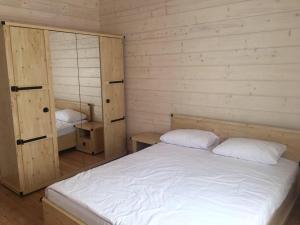 a bedroom with a bed and two bunk beds at Villa Blumarine in Zatoka