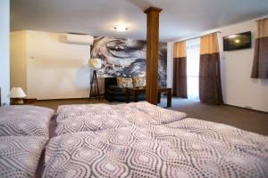 a bedroom with a bed and a living room at Penzión Anima in Kaluža +15 photos