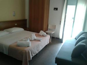 Postel nebo postele na pokoji v ubytování G/Hotel Lignano