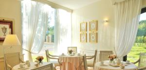 a dining room with two tables and a large window at Villa Agnese in Sestri Levante