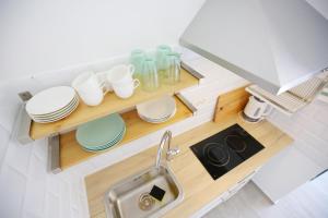a kitchen with a sink and some dishes on a shelf at Apartments Villa Navi in Bibinje +60 photos