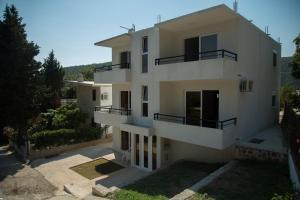 a large white building with balconies on it at Del Mar Apartments in Čanj