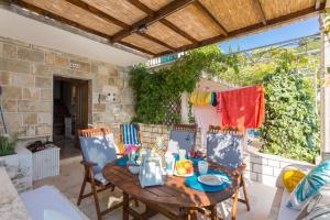 a patio with a wooden table and chairs at Nono Frano in Prožura +81 photos