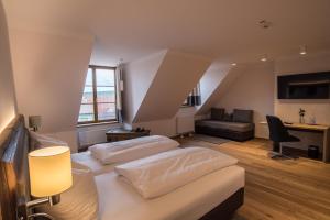 um quarto com 2 camas e uma sala de estar em Brennereihotel Sponsel em Kirchehrenbach