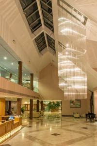 a large lobby with a large chandelier hanging from the ceiling at East Sussex National Hotel, Golf Resort & Spa in Uckfield +64 photos
