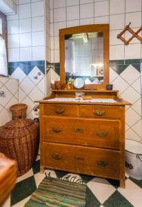 a bathroom with a wooden dresser and a mirror at Country House "Stričev grunt" Stara Kapela in Stara Kapela +42 photos