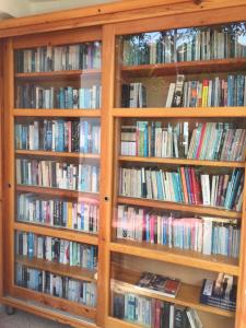 a book shelf filled with lots of books at On Hotel in Adrasan