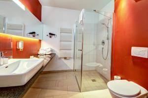 a bathroom with a shower and a toilet and a sink at AlpenParks Hotel Maria Alm in Maria Alm am Steinernen Meer