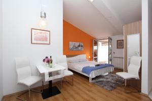 sypialnia z łóżkiem, stołem i krzesłami w obiekcie Apartments Tanja w Rovinj