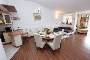 a dining room and living room with a table and chairs at Apartments Tanja in Rovinj +38 photos