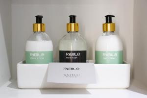 three bottles of soap in a box on a shelf at Rabble in Edinburgh