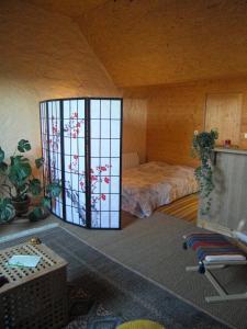 a room with a bed and a large window at Les Hirondelles in Sainte-Suzanne