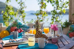 a table with a breakfast of juice and fruit at Nono Frano in Prožura