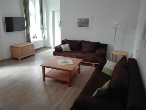 a living room with a couch and a coffee table at Gasthaus Wagner in Golzow