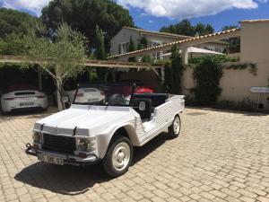 a white pick up truck parked in a driveway at Villa La Begude - Boutique B&B in Saint-Tropez