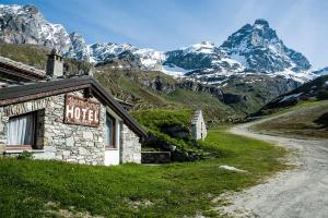 a hotel sign on the side of a mountain at Hotel Baita Cretaz in Breuil-Cervinia