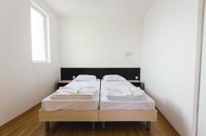 A bed or beds in a room at Plovdiv Hotel