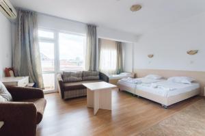 A bed or beds in a room at Plovdiv Hotel