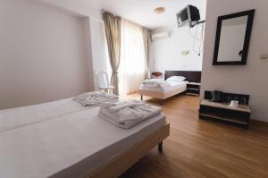 A bed or beds in a room at Plovdiv Hotel