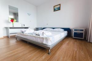 A bed or beds in a room at Plovdiv Hotel