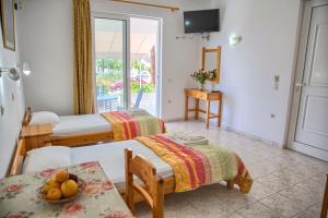 a room with two beds and a table with fruit on it at Haraki View in Haraki