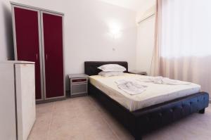 A bed or beds in a room at Plovdiv Hotel