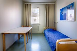 a small room with a bed and a table at Eurohostel in Helsinki