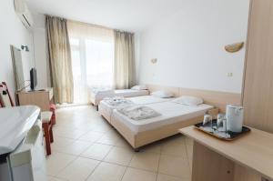 A bed or beds in a room at Plovdiv Hotel