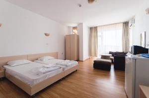 A bed or beds in a room at Plovdiv Hotel