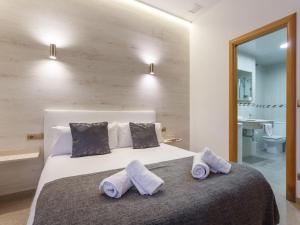 Postel nebo postele na pokoji v ubytování Aparthotel Rambla108