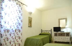 una camera con due letti e una tenda con fiori di Trullo delle Querce Suite Private Pool a Martina Franca Altre 21 foto