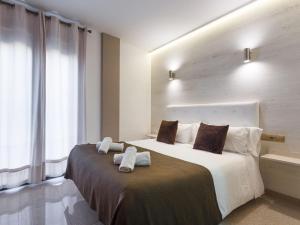 Postel nebo postele na pokoji v ubytování Aparthotel Rambla108
