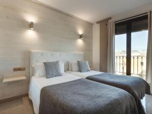 Postel nebo postele na pokoji v ubytování Aparthotel Rambla108