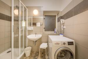 a bathroom with a washing machine and a sink at Apartments 39 Wenceslas Square in Prague