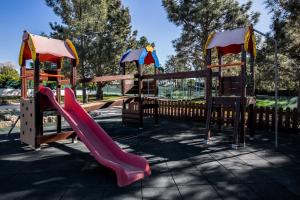 a playground with a slide in a park at Vale d'El Rei Hotel & Villas in Carvoeiro