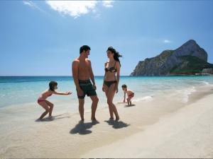 a group of people walking on the beach at AR Roca Esmeralda & SPA Hotel in Calpe