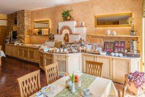 a large kitchen with tables and chairs in a room at Ferienhotel Innviertel in Kirchheim im Innkreis