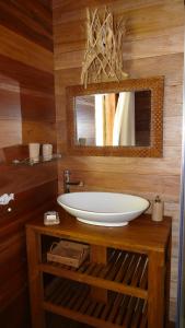 a bathroom with a sink and a mirror at Lakaz An Bwa in La Digue