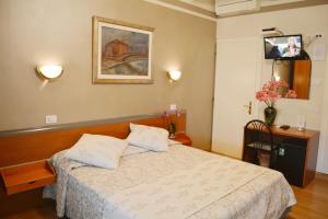 a bedroom with a bed and a picture on the wall at Villa Chiara in Lazise +54 photos