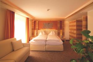 Postel nebo postele na pokoji v ubytování Hotel Garni Muttler Alpinresort & Spa