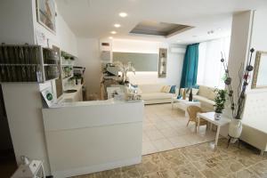 a living room with a couch and a table at Hotel Ermeti B&B Brunch in Riccione