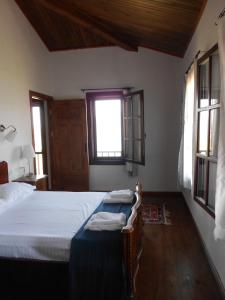 a bedroom with a bed and a window at Selimiye Houses in Selimiye